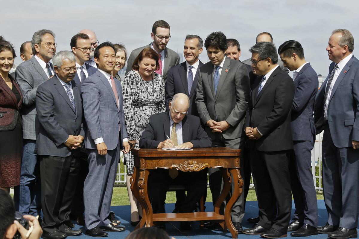 Gov. Jerry Brown signs 15 housing laws in 2017 in San Francisco.