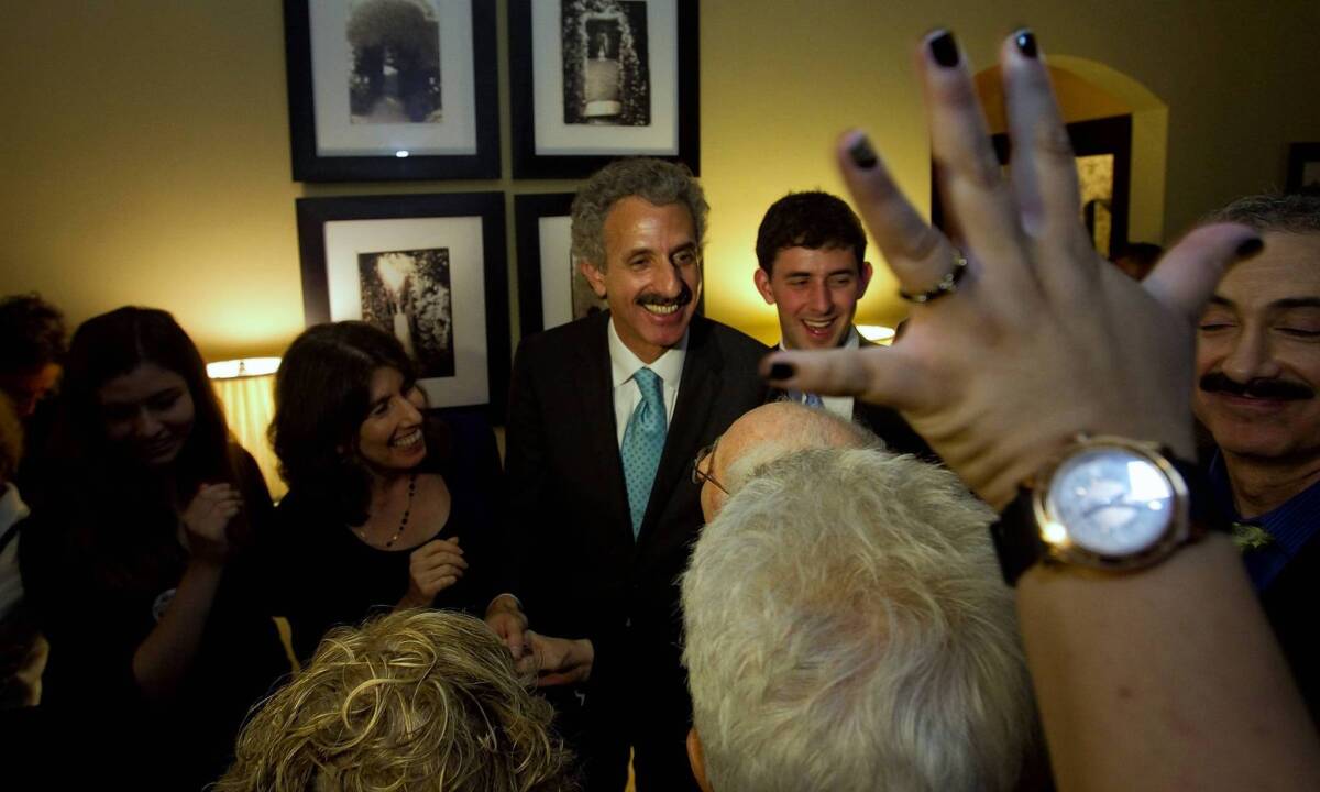 In a harshly worded ruling, Judge Richard Rico agreed with Mike Feuer, shown with supporters on election night, that the suit was more about political gamesmanship than protecting the public interest.