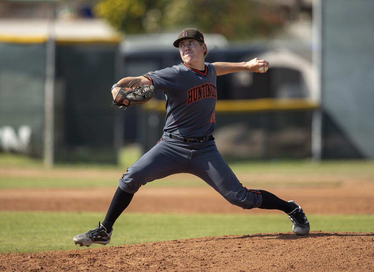 Huntington Beach's Ben Jacobs pitches against Edison during a Surf League game on April 1.