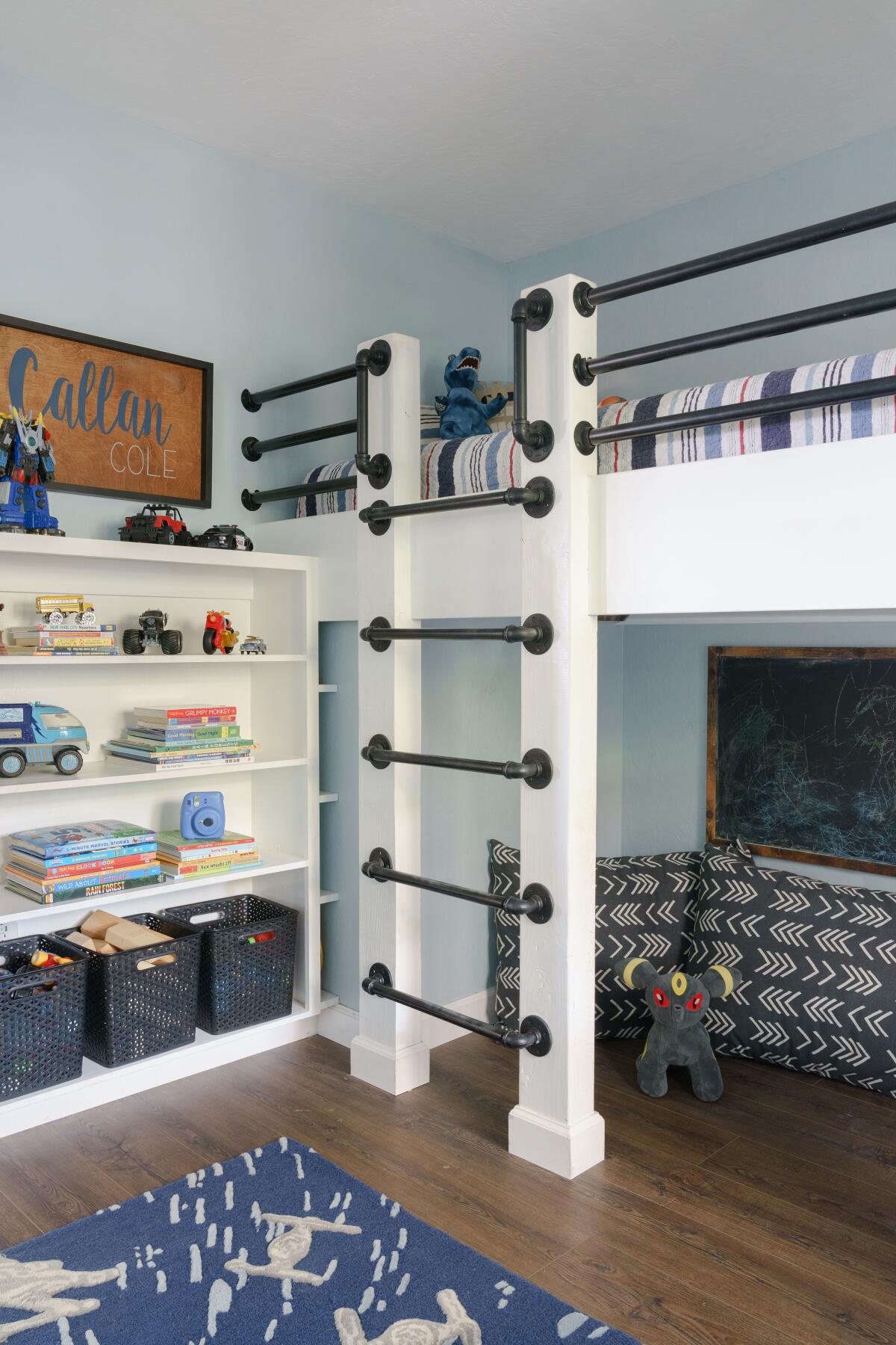 A boys room in a "farmhouse luxe" project has sturdy climbing racks to the bed above and play space below.