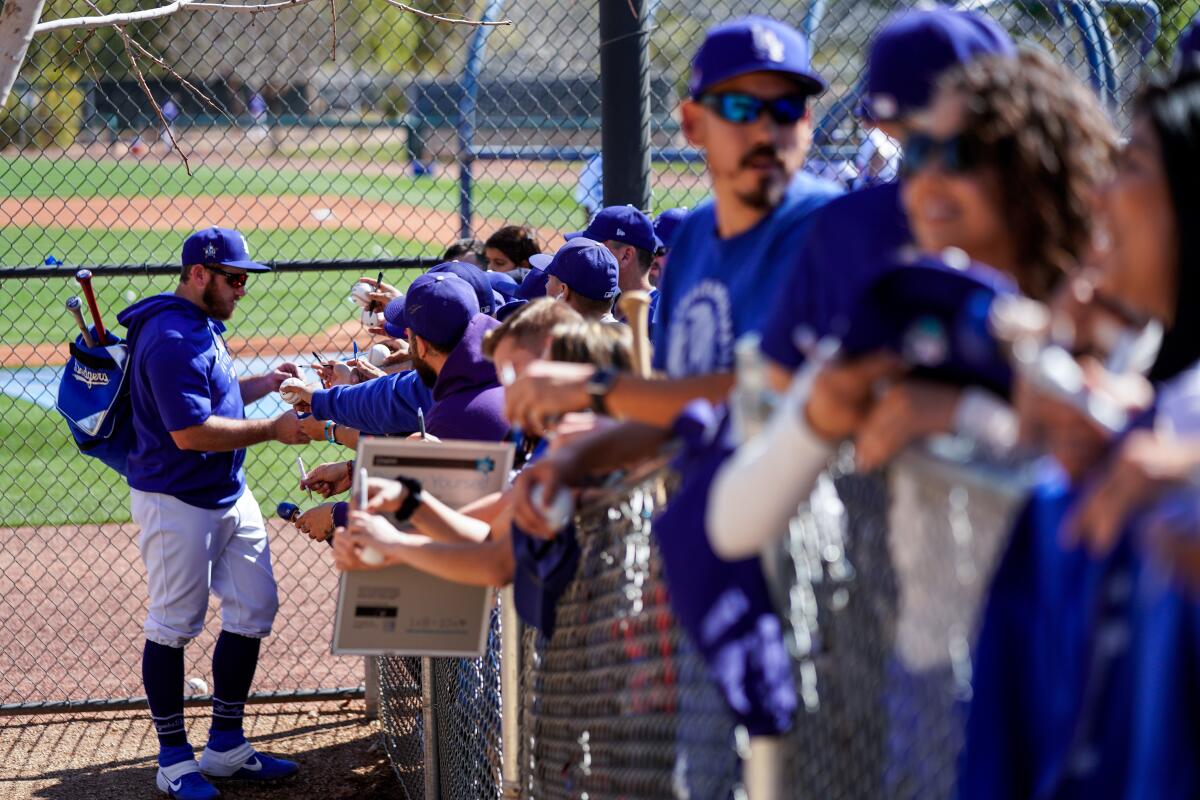 Max Muncy signs autographs for fans after practice Feb. 20 in Phoenix.