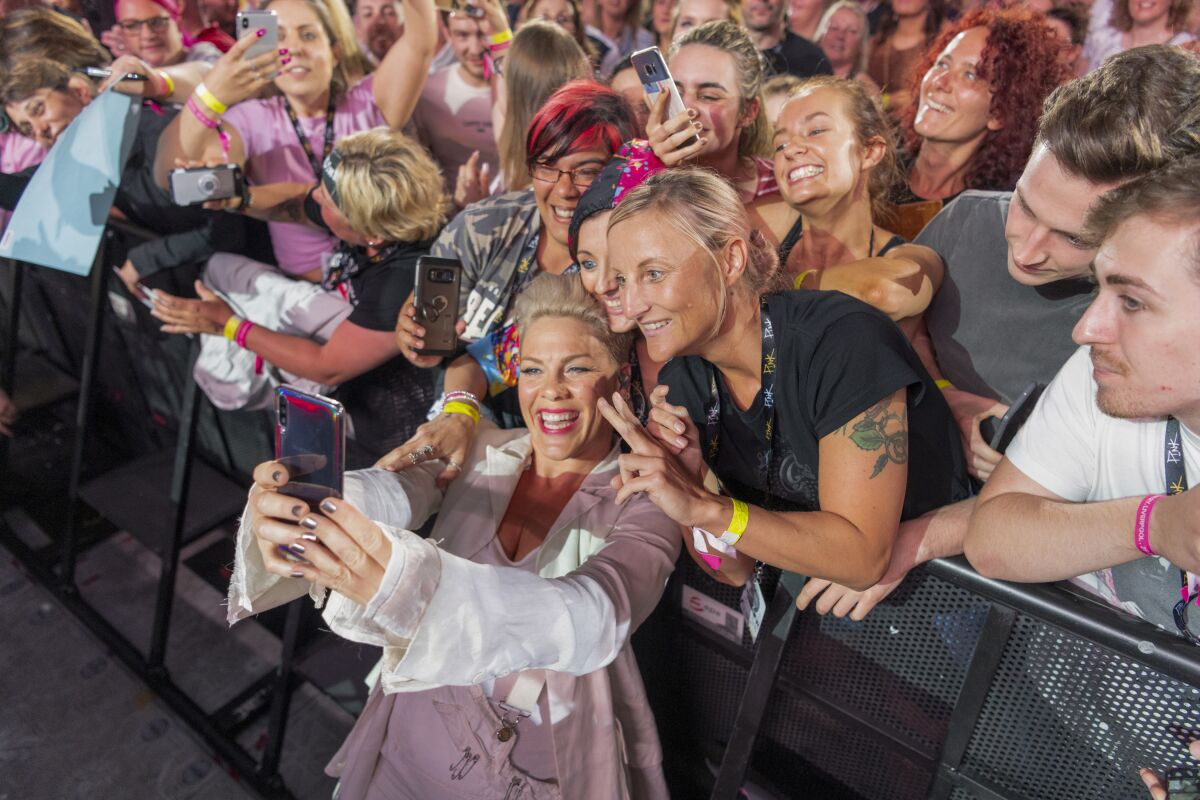 Pop star Pink takes a selfie with fans