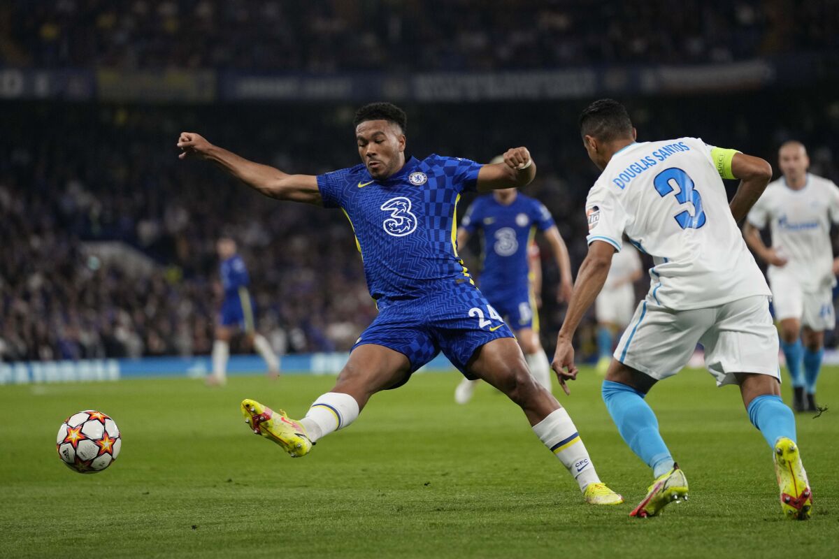 Chelsea's Reece James, left, challenges for the ball with Zenit's Douglas Santos during the Champions League Group H soccer match between Chelsea and Zenit St Petersburg at Stamford Bridge stadium in London Tuesday, Sept. 14, 2021. (AP Photo/Kirsty Wigglesworth)