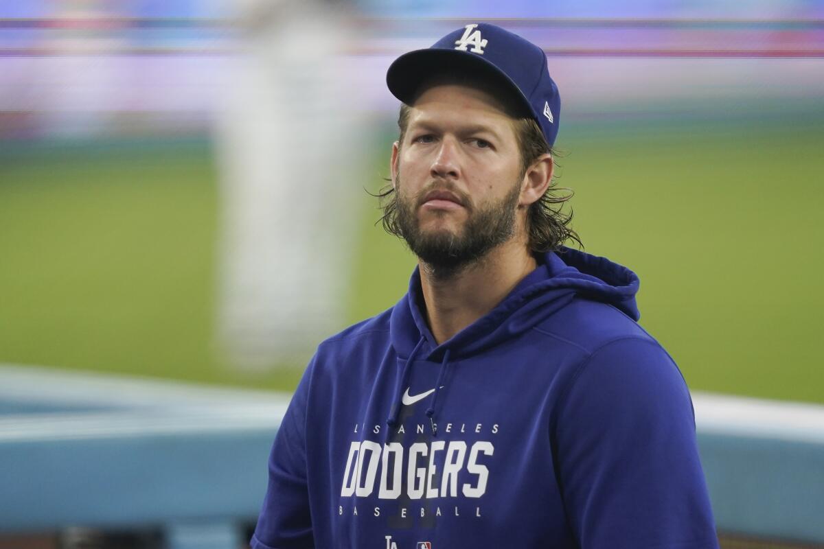 Dodgers player Clayton Kershaw stands in the dugout before a game against the Arizona Diamondbacks on Aug. 30.