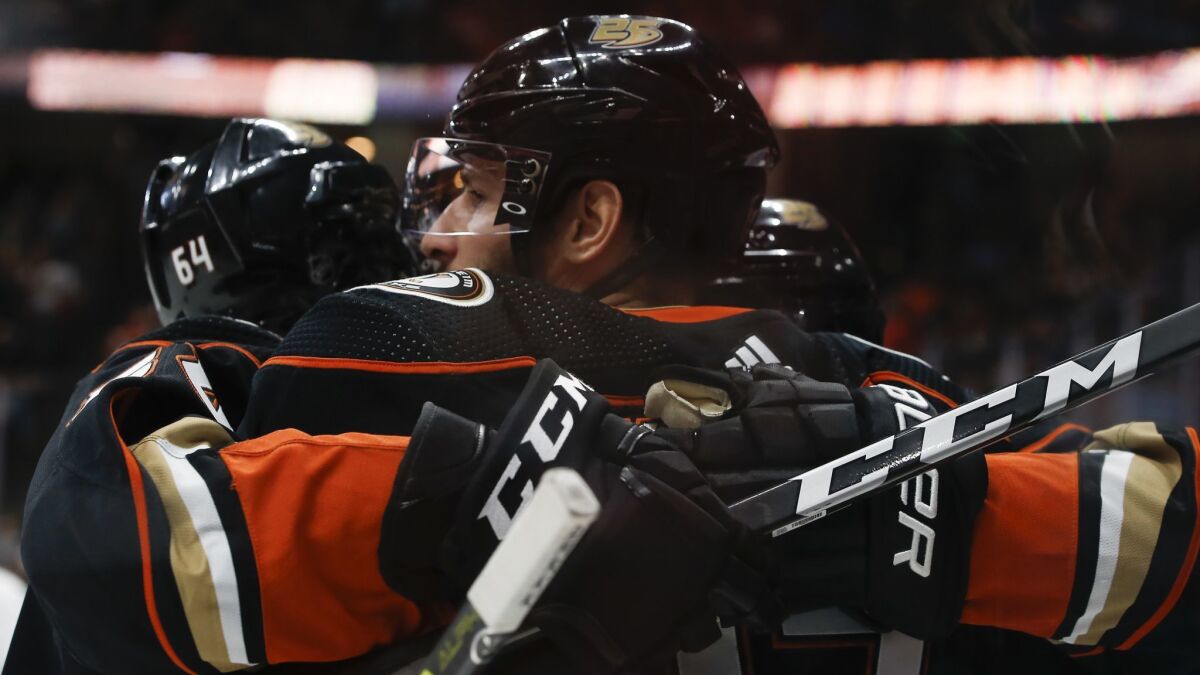Ducks center Ryan Kesler, center, celebrates scoring a goal against the New York Islanders with right wing Kiefer Sherwood, left, during the second period.