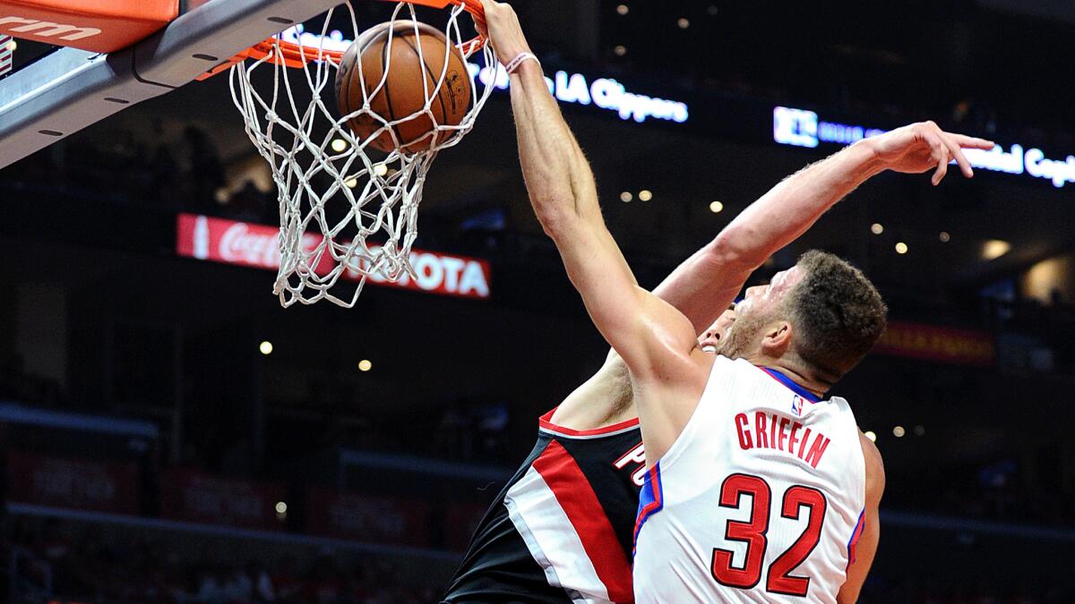 Clippers forward Blake Griffin dunks over Blazers center Mason Plumlee, who is called for a foul on the play in Game 1 on Sunday night at Staples Center.