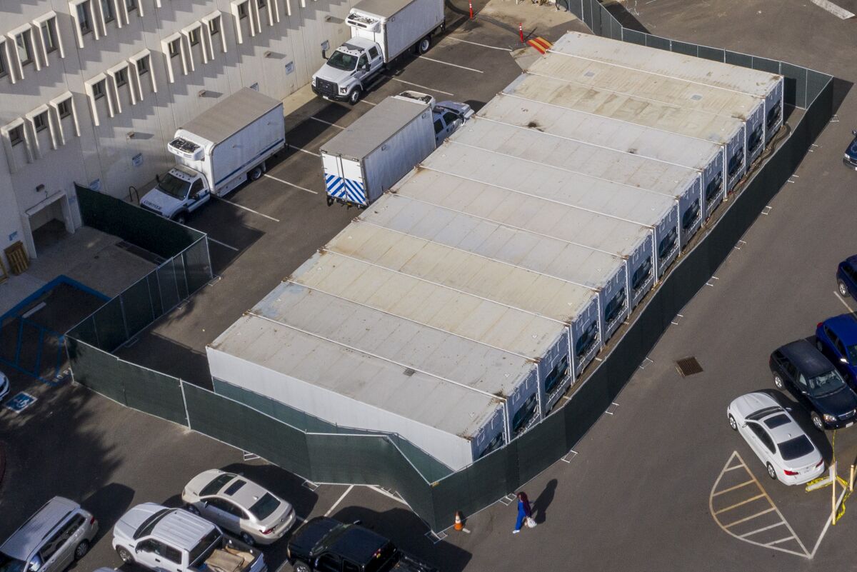 A dozen refrigerated storage trailers are parked at the Los Angeles County coroner's complex on Thursday.