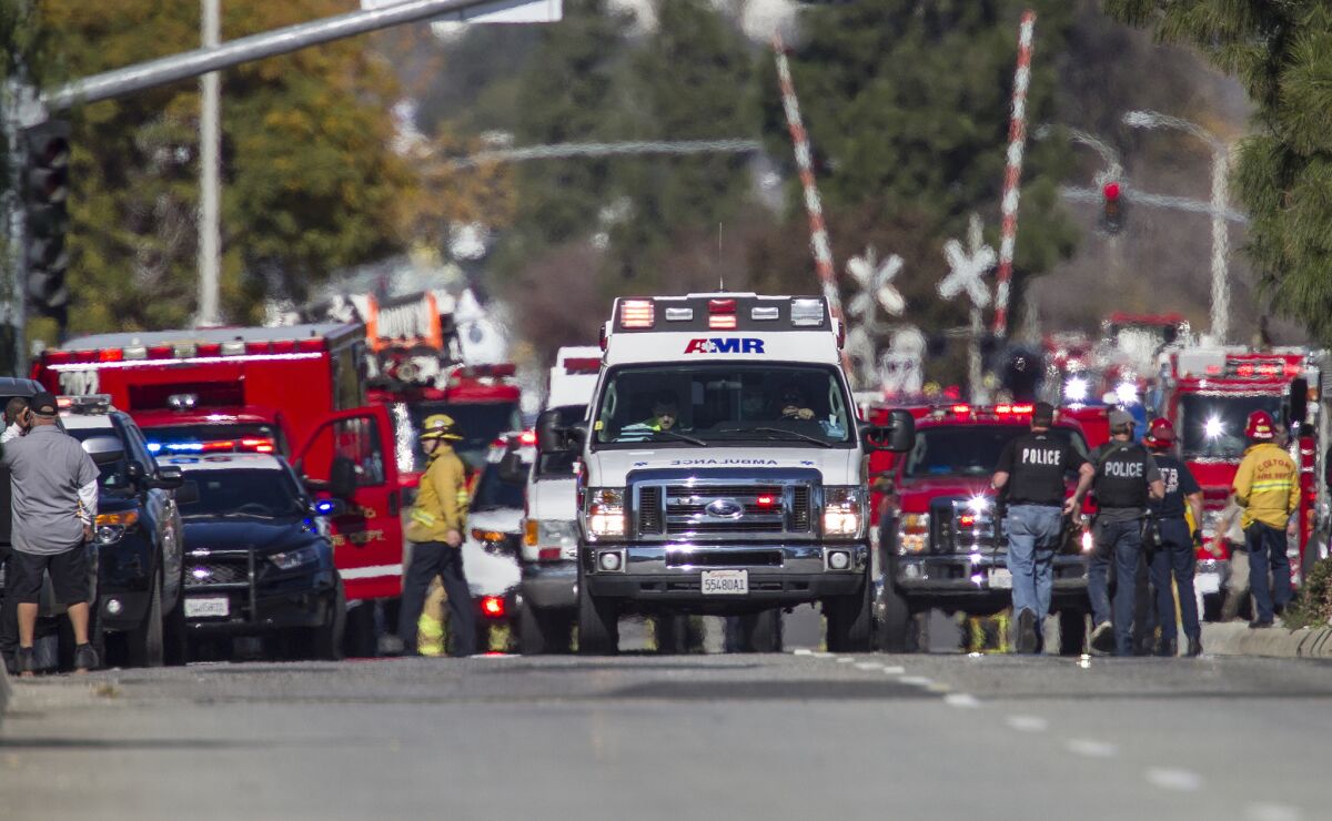 Ambulances leave the hectic scene of a mass shooting at the Inland Regional Center in San Bernardino.