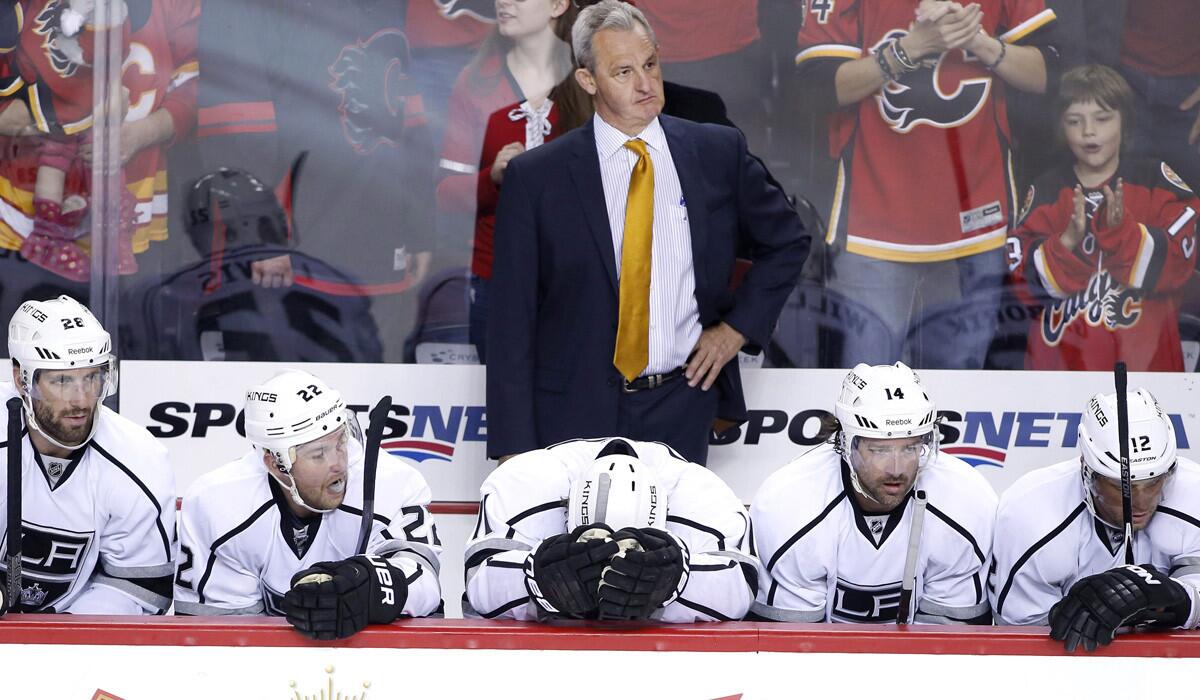 Kings Coach Darryl Sutter stands behind players as the Calgary Flames scored during a 3-1 loss to the Flames on Thursday.