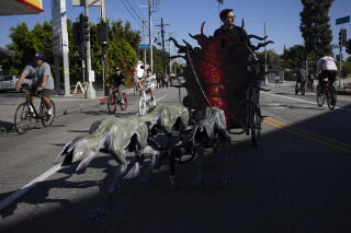 Participants bike past a "Demogorgon sleigh"