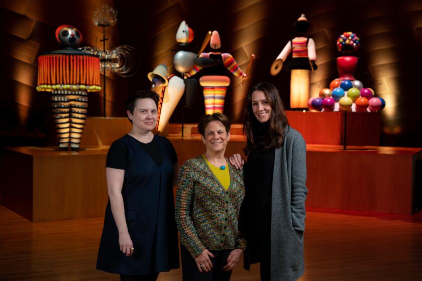 LOS ANGELES, CALIF. - FEBRUARY 04: Julia Ward, Stephanie Barron and Nana Bahlmann pose for a portrait with Oskar Schlemmer’s “The Triadic Ballet” behind them at the Walt Disney Concert Hall on Tuesday, Feb. 4, 2020 in Los Angeles, Calif. (Kent Nishimura / Los Angeles Times)