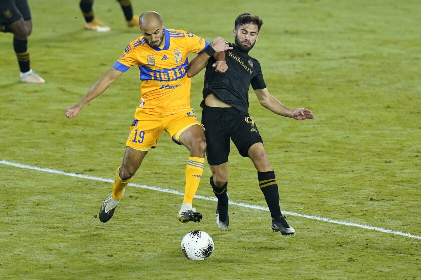 Tigres midfielder Guido Pizarro (19) and Los Angeles FC forward Diego Rossi compete for possession of the ball during the first half of a CONCACAF Champions League soccer match Tuesday, Dec. 22, 2020, in Orlando, Fla. (AP Photo/John Raoux)