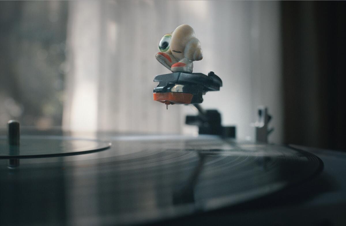 An animated shell on the arm of a turntable.