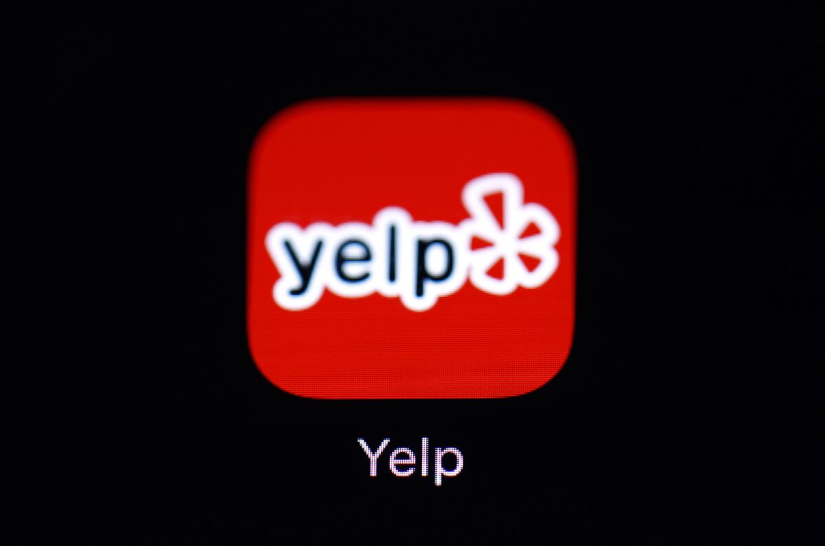 FILE- This March 19, 2018, file photo shows the Yelp app on an iPad in Baltimore. Yelp reports financial results Thursday, Nov. 7, 2019. The online review service will cover the travel expenses of employees who have to travel out of state for abortions, joining the ranks of major employers trying to help workers affected by restrictions being placed on the procedure in Texas and other states. The benefit announced Tuesday, April 12, 2022 covers Yelp's entire workforce of 4,000 employees, but seems most likely to have its biggest immediate impact on its 200 workers in Texas, which has passed a law banning abortions within the state after six weeks of pregnancy. (AP Photo/Patrick Semansky, File)