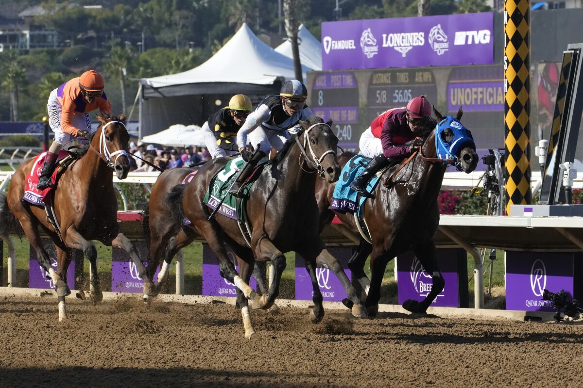 Jockey Jose Ortiz makes a hard charge to the finish line riding Aloha West in the Breeders’ Cup Sprint at Del Mar.