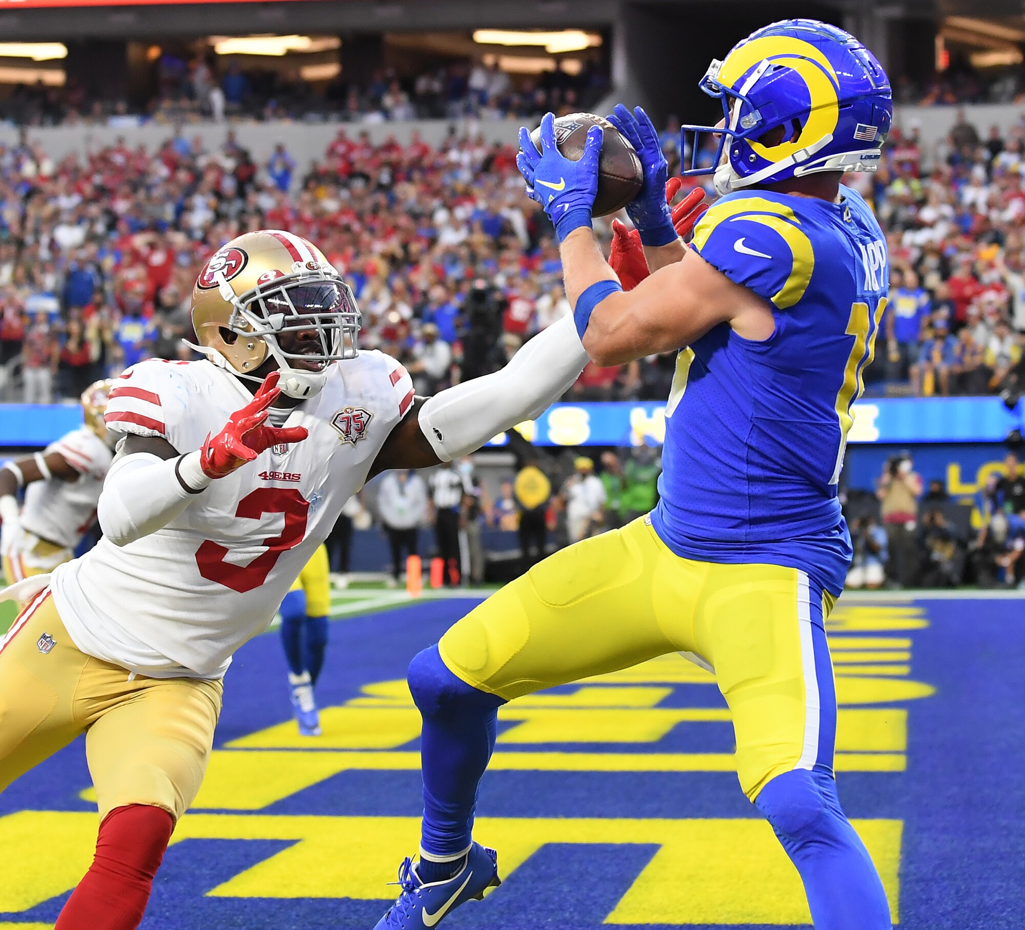 Rams receiver Cooper Kupp catches a touchdown pass in front of 49ers safety Jaquiski Tartt.