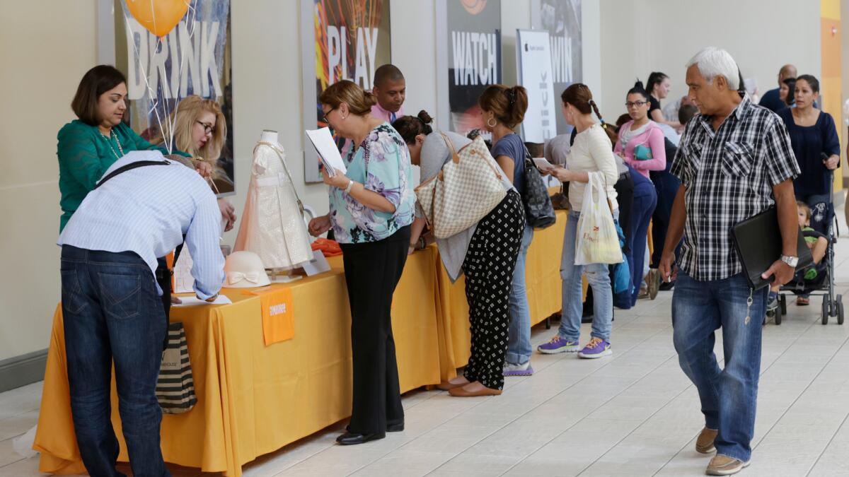 Applicants fill out forms during a job fair in Miami last year.