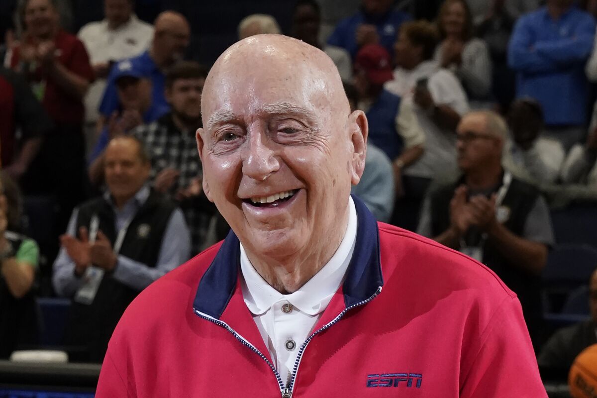 FILE - ESPN sportscaster Dick Vitale poses before an NCAA college basketball game between between Texas A&M and Arkansas at the Southeastern Conference tournament Saturday, March 12, 2022, in Tampa, Fla. Longtime college basketball broadcaster Dick Vitale is celebrating after finishing chemotherapy at Sarasota Memorial Hospital in Florida. He tweeted Thursday, April 14, 2022, that he was cancer-free, and posted a video of himself ringing the bell in excitement. (AP Photo/Chris O'Meara, File)