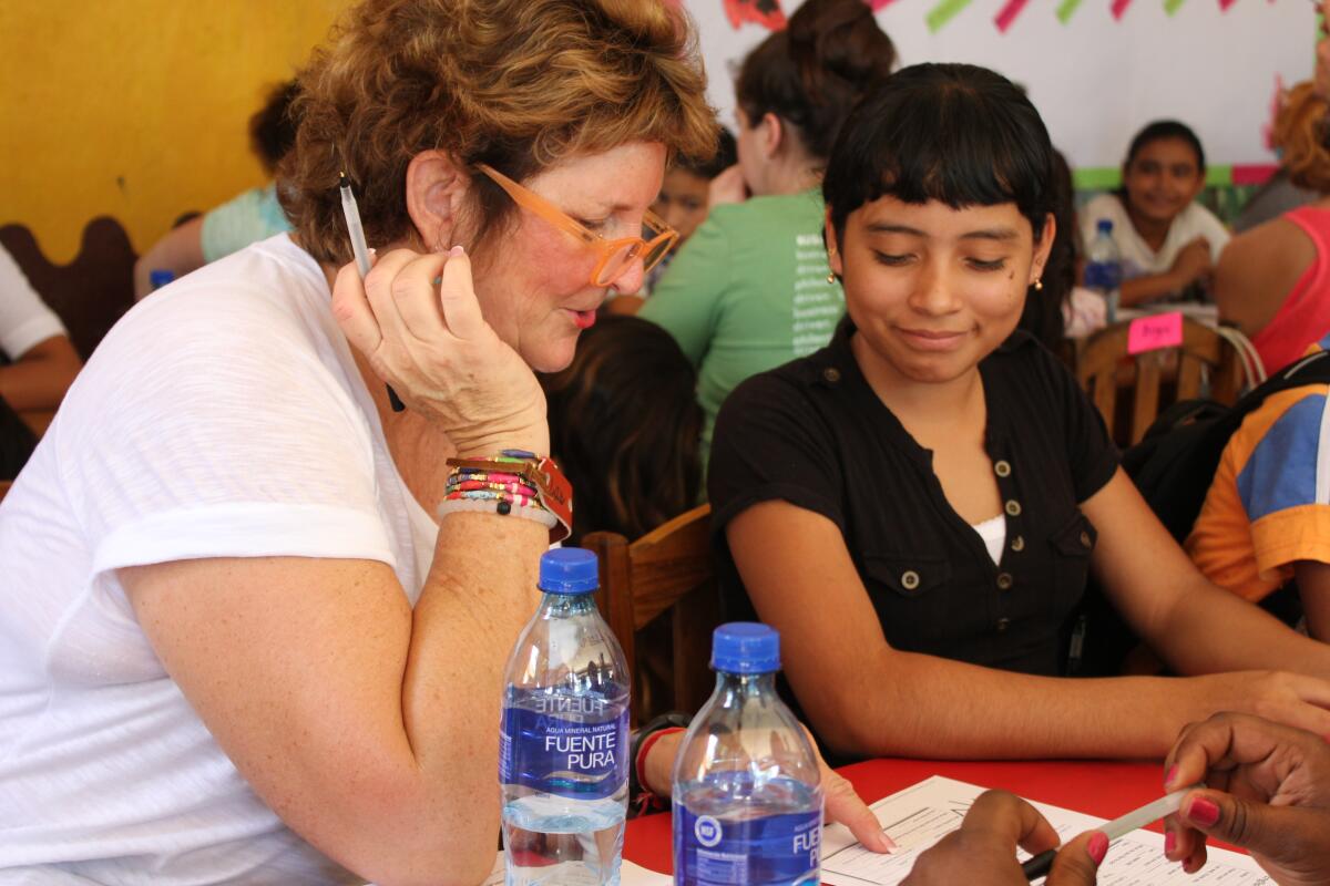 Julie Tafel Klaus works with a student at La Tias in Nicaragua.