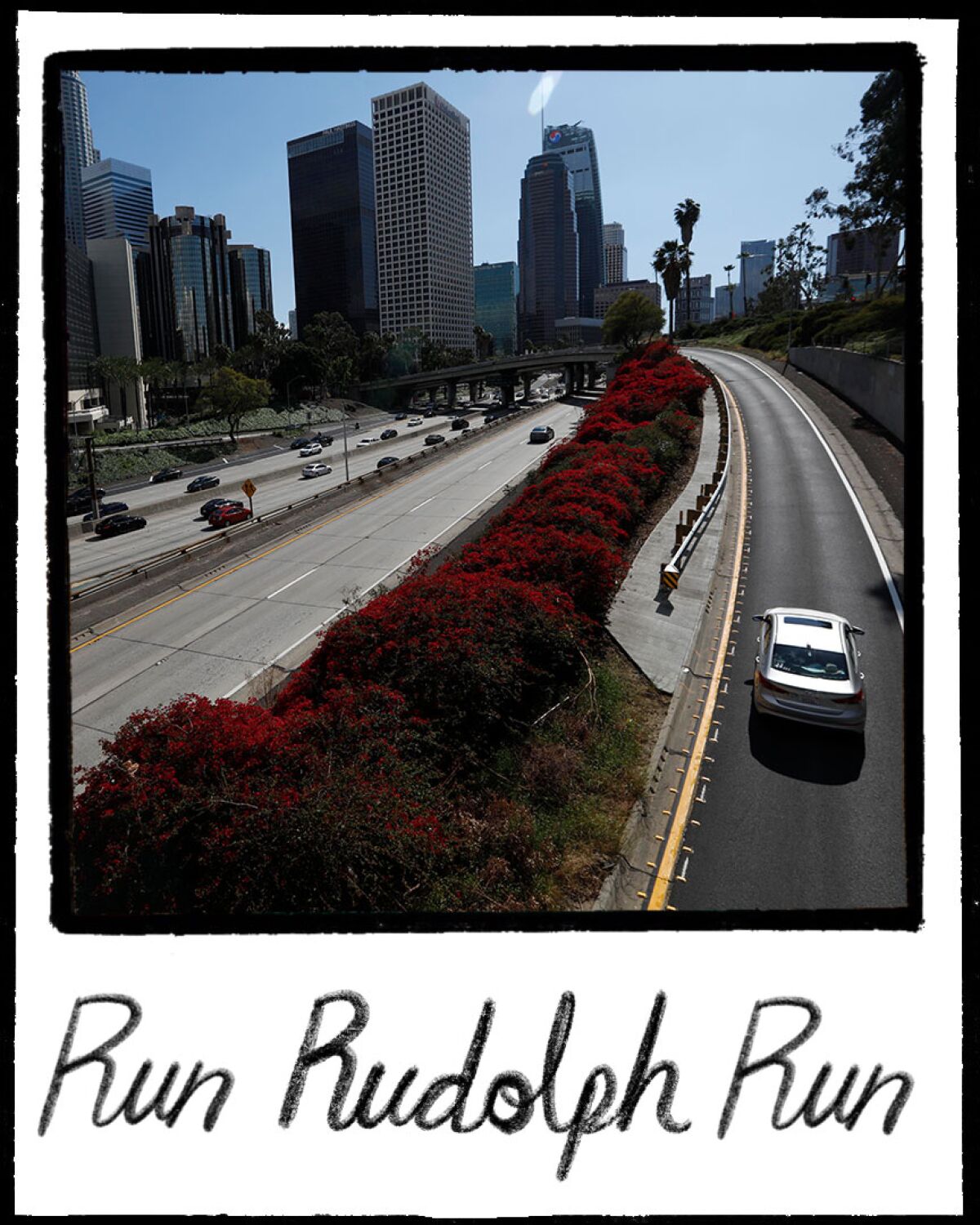 An illustration resembles a Polaroid photo of L.A. high-rises, light traffic on the 110 and the words "Run Run Rudolph."