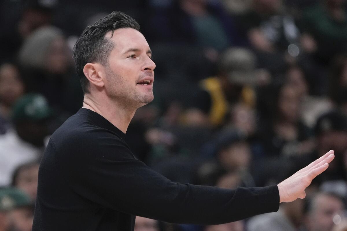 Lakers head coach JJ Redick reacts during the first half of an NBA preseason game.