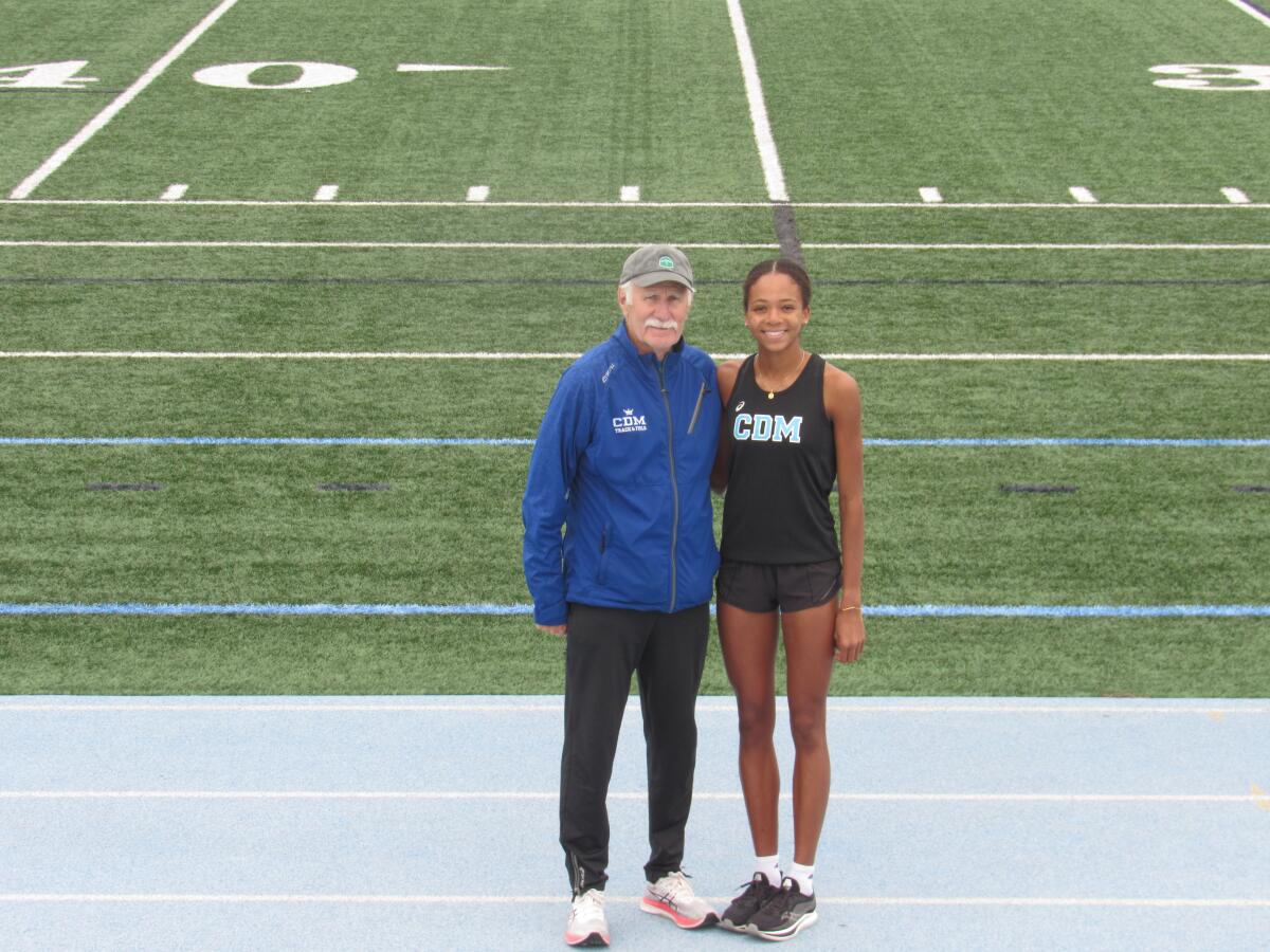 Corona del Mar senior Melisse Djomby Enyawe, right, poses for a picture with Sea Kings coach Bill Sumner.