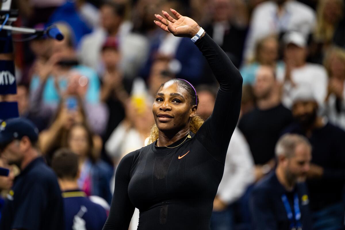 Serena Williams waves to the crowd after defeating Maria Sharapova at the U.S. Open on Monday.