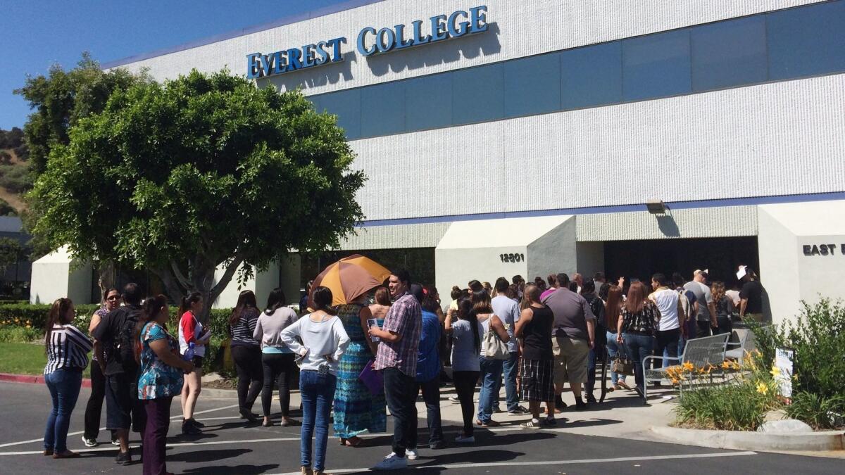 Students wait outside Everest College in Industry in April 2015. California Atty. Gen. Xavier Becerra announced $67 million in debt relief for 35,000 former students of Corinthian Colleges.