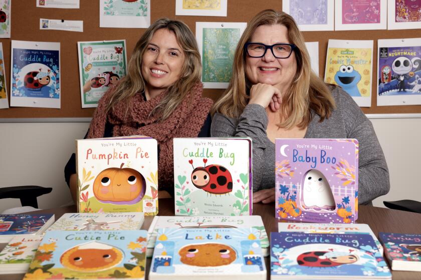 SAN DIEGO, CA - DECEMBER 14, 2023: Associate Publisher and Editorial Director, Kaitlyn Lockwood, left, and Vice President, Publisher, Debra Zakarin with the series of children's books they published at Printers Row Publishing Group in San Diego on Thursday, December 14, 2023. (Hayne Palmour IV / For The San Diego Union-Tribune)