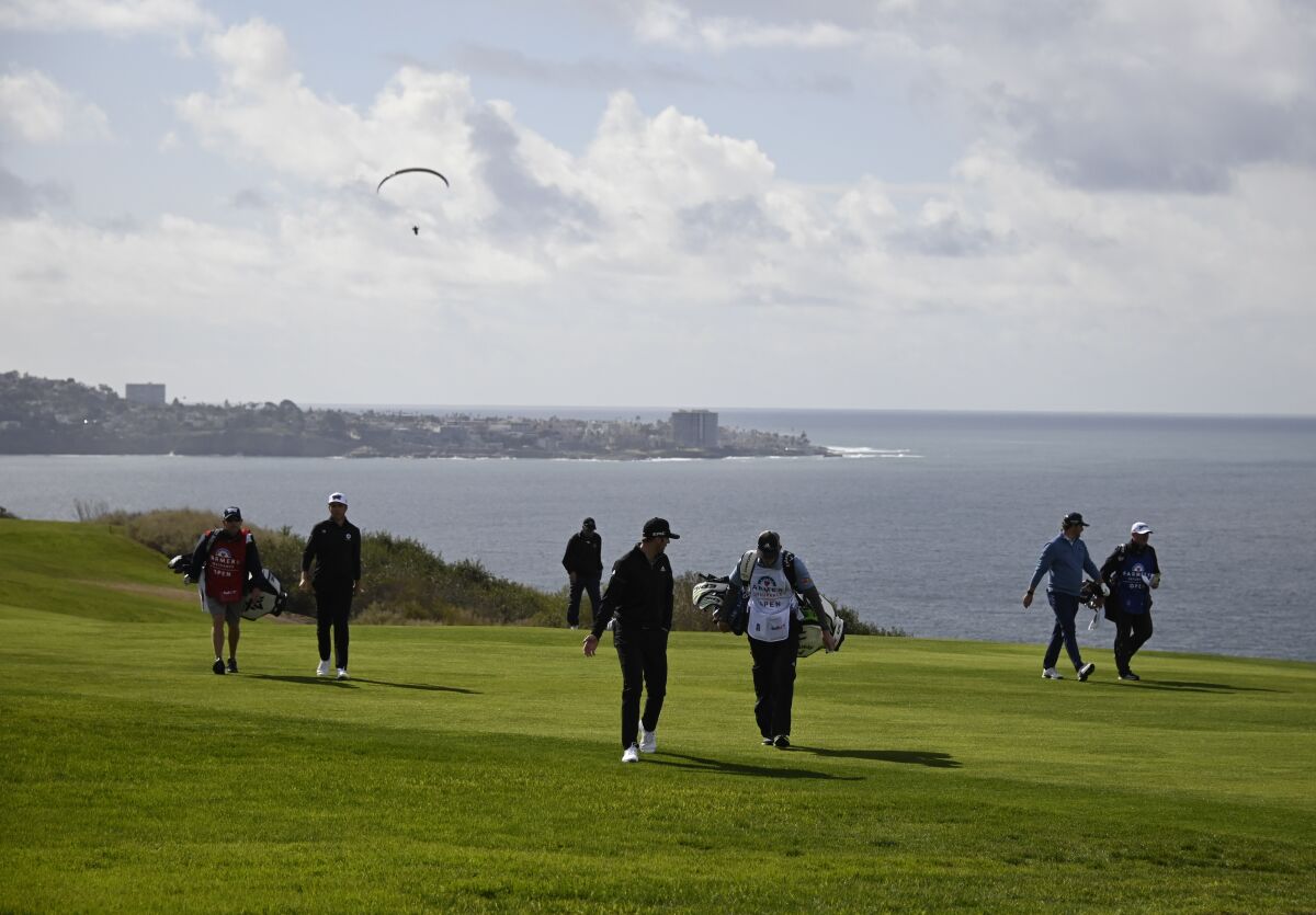 Golfers walk along the fourth hole of the South Course during the Farmers Insurance Open at Torrey Pines in January.