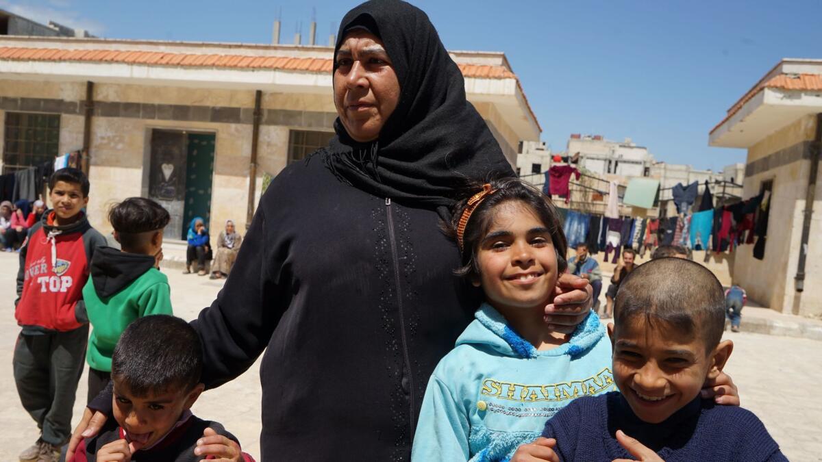 Fariha Ziab, from the town of Palmyra, with three of her five children at a shelter for displaced families in Homs, Syria.