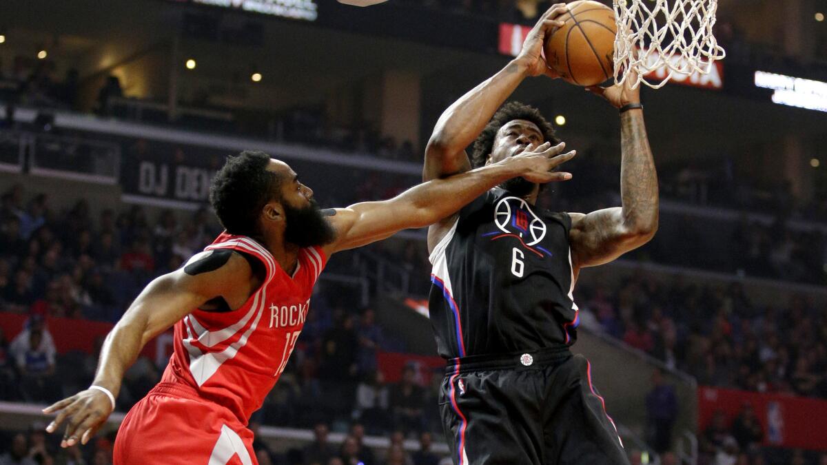 Clippers center DeAndre Jordan is fouled by Rockets forward James Harden in the first half Saturday.