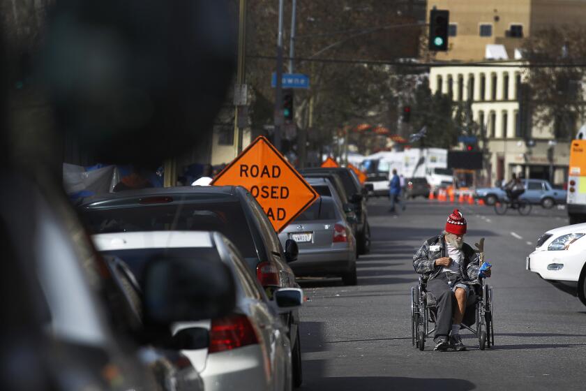 Davy, a Navy veteran who did not give his last name, pushes his wheelchair during a 2014 skid row drive by Vet Hunters, a nonprofit veterans support group, to get veterans off the streets.