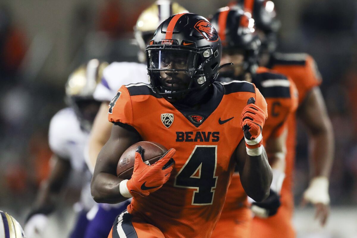 Oregon State running back B.J. Baylor (4) rushes for 27-yards to score a touchdown during the second half of an NCAA college football game against Washington on Saturday, Oct. 2, 2021, in Corvallis, Ore. Oregon State won 27-24. (AP Photo/Amanda Loman)