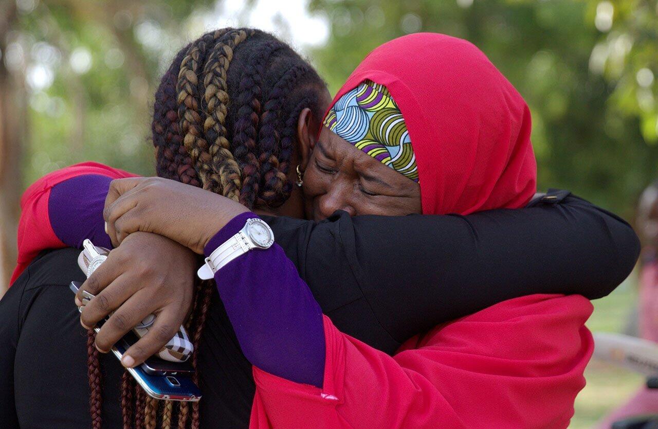 Members of the #BringBackOurGirls campaign embrace in Abuja, Nigeria. A Nigerian teenager kidnapped by Boko Haram more than two years ago has been rescued, the first of more than 200 girls seized in a raid on their schoo to return from captivity.
