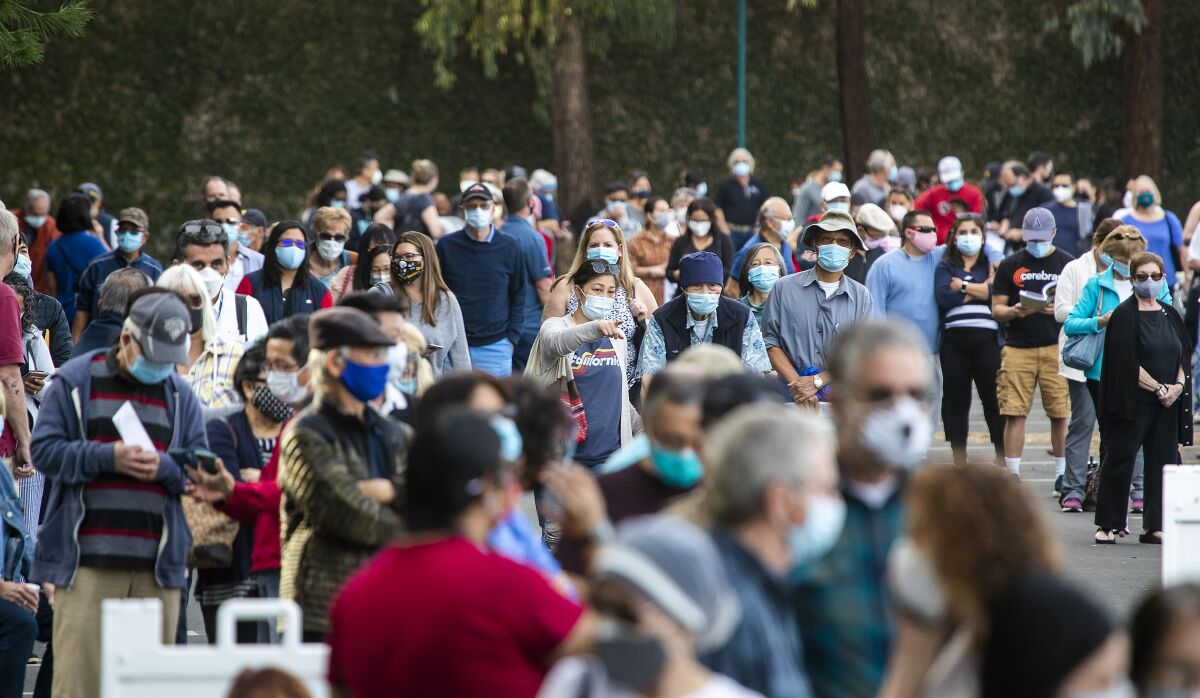 Healthcare workers wait in line to receive the COVID-19 vaccine at the Disneyland Resort in Anaheim.