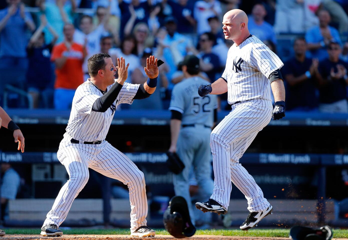 The Yankees' Brian McCann celebrates his game-winning home run in 10th inning off the White Sox's Jake Petricka.