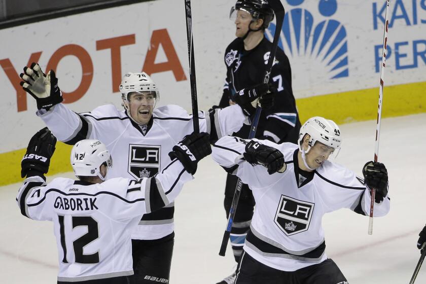 The Kings' Vincent Lecavalier, right, celebrates his goal with teammates Tanner Pearson and Marian Gaborik (12) as San Jose's Paul Martin skates past during the third period on Sunday night.