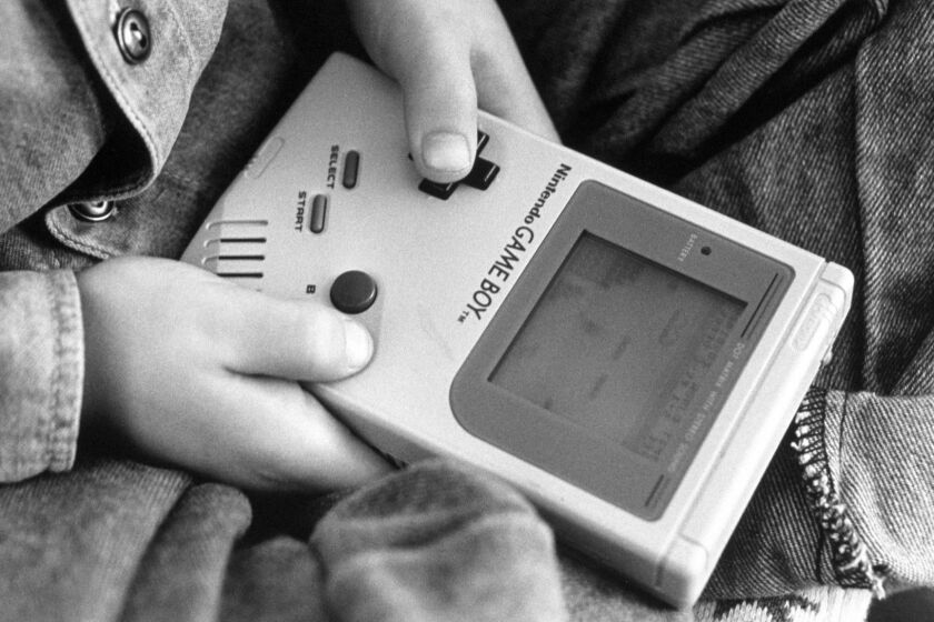 London - A boy playing on one of the first Nintendo Game Boy computers (Photo by In Pictures Ltd./Corbis via Getty Images)
