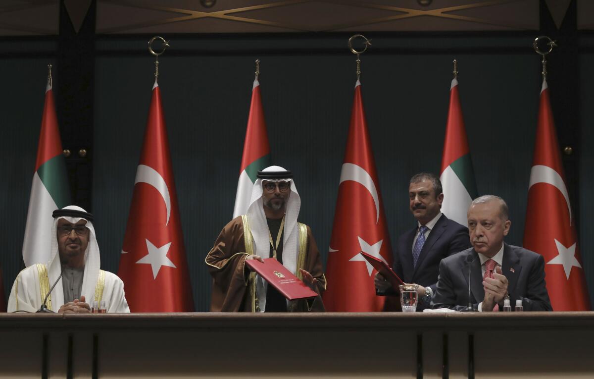 FILE - Turkey's President Recep Tayyip Erdogan, right, and Sheikh Mohammed bin Zayed Al Nahyan, left, the Crown Prince of the United Arab Emirates attend a signing ceremony at the presidential palace, in Ankara, Turkey, Wednesday, Nov. 24, 2021. The Turkish central bank says it and the United Arab Emirates have agreed to a currency swap deal equivalent to $4.74 billion to boost Turkey’s depleted foreign exchange reserves. Under the agreement announced Wednesday, Jan. 19, 2022, Turkey and the UAE agreed to swap 65 billion Turkish lira and 18 billion UAE dirham for a period of three years, with the possibility of extending the deal further. (AP Photo/Burhan Ozbilici, File)