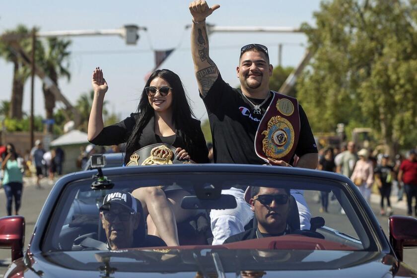Heavyweight boxing champion and hometown hero Andy Ruiz Jr. and his wife, Julie, wave to a cheering crowd while sitting in a Rolls Royce during a parade on Saturday, June 22, 2019, honoring him in his hometown of Imperial, Calif. (Hayne Palmour IV/San Diego Union-Tribune/TNS) ** OUTS - ELSENT, FPG, TCN - OUTS **
