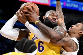Los Angeles, California April 28, 2023-Lakers LeBron James grabs a rebound from Grizzlies Ja Morant in the first quarter in Game 6 of the NBA playoffs at Crypto.com arena Friday. (Wally Skalij/Los Angeles Times)