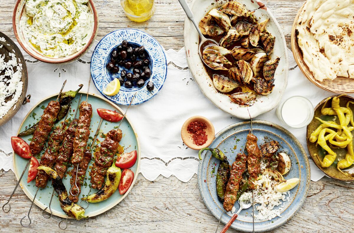 Adana Kebabs, served with tzatziki, pickles and grilled onion salad, a traditional grilled