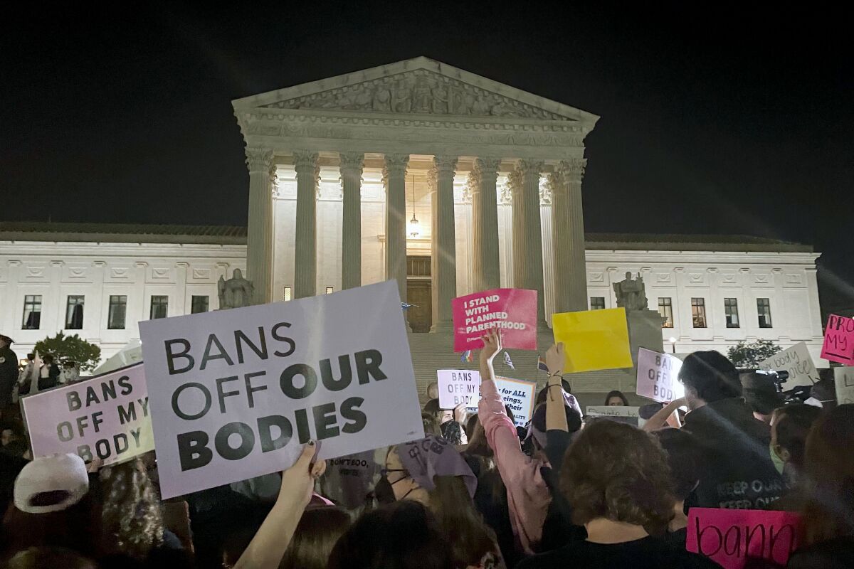 A crowd of people gather outside the Supreme Court on May 2 in Washington.