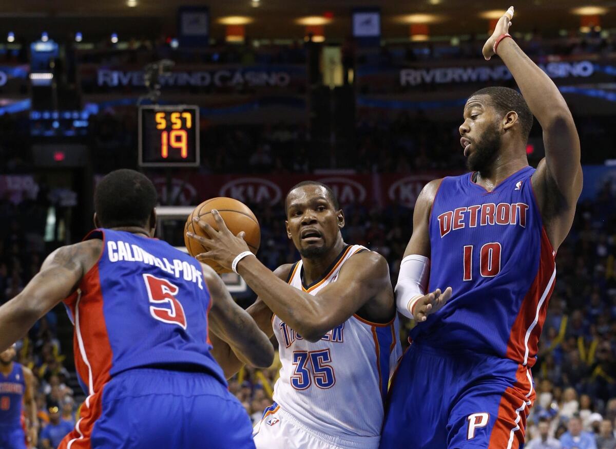 Oklahoma City's Kevin Durant, center, splits the defense of Kentavious Caldwell-Pope, left, and Greg Monroe, right, en route to a 42 point performance in the Thunder's 112-111 win over the Pistons.