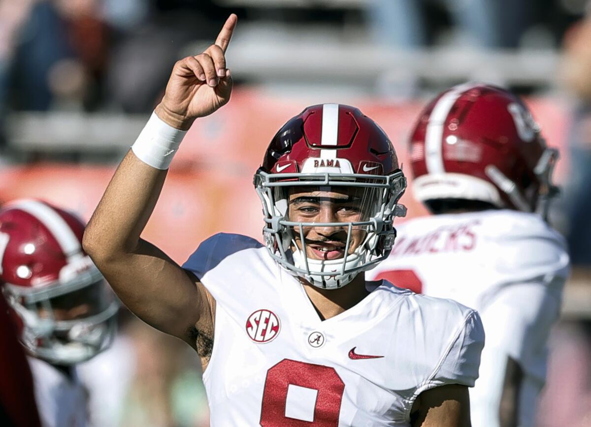 FILE - Alabama quarterback Bryce Young (9) during warm ups before the start of an NCAA college football game against Auburn on Nov. 27, 2021, in Auburn, Ala. Alabama is banking on Young and Will Anderson Jr. to lead the team back to a national championship after a tantalizingly close call last season. Both are high on the lists of preseason Heisman Trophy candidates and potential No. 1 NFL draft picks. (AP Photo/Butch Dill, File)
