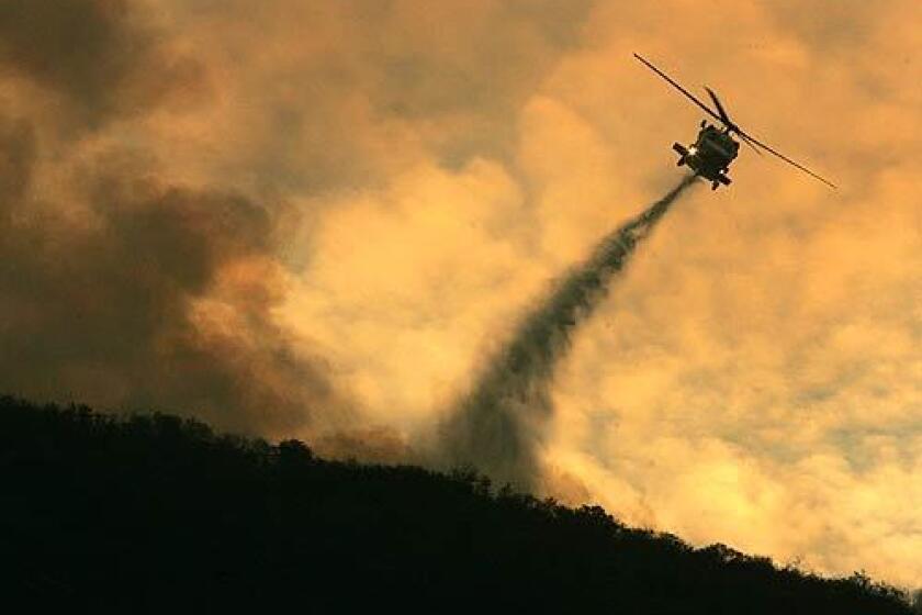 The battle to save Silverado Canyon was fought in the air with numerous helicopters circling in for water drops past sundown. The choppers managed to confine the advancing flames to several ridgetops above Silverado Cayon.