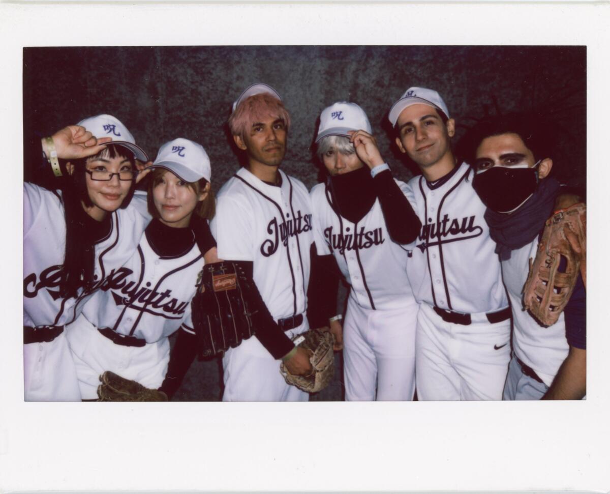 Six men and women wearing baseball uniforms with the word "Jujutsu" written on the front.
