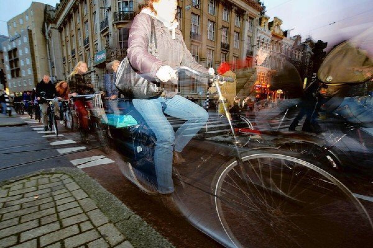 Commuters ride their bikes in late afternoon traffic near Amsterdam Central Station on Nov. 2, 2012.