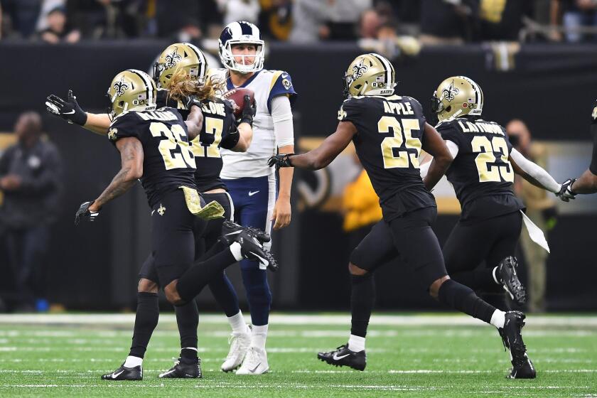 Rams quarterback Jared Goff can only watch as New Orleans Saint players celebrate an interception late in the second quarter that lead to a touchown at the Mercedes Benz Superdome in New Orleans on Sunday.